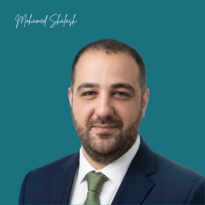 Professional headshot of Mohamed Shalash in a navy suit and green tie against a teal background.